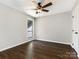 Bedroom with dark floors, a neutral color scheme, and a ceiling fan with lighting at 7378 Winery Ln, Charlotte, NC 28227