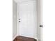 Solid white front door with decorative panels, complemented by dark hardware at 7378 Winery Ln, Charlotte, NC 28227