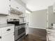 Updated kitchen with stainless steel appliances, white cabinets, and a breakfast bar with seating at 7378 Winery Ln, Charlotte, NC 28227