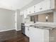 Updated kitchen featuring white cabinets, stainless steel appliances, granite countertops, and modern fixtures at 7378 Winery Ln, Charlotte, NC 28227