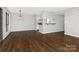 Open-concept living area with dark floors, a fireplace, and a view into the updated kitchen at 7378 Winery Ln, Charlotte, NC 28227