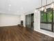 Large open living room with wood flooring, a fireplace, and a sliding glass door overlooking the backyard at 7378 Winery Ln, Charlotte, NC 28227