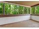 Screened porch with wood floors surrounded by windows showcasing a beautiful view of the trees at 7378 Winery Ln, Charlotte, NC 28227