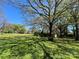 Spacious backyard with a large tree and shed at 915 Timberlane Dr, Mount Holly, NC 28120