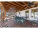 Enclosed porch features a ceiling fan, dining furniture, and an open view to the backyard at 915 Timberlane Dr, Mount Holly, NC 28120