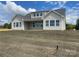 Back exterior of a home with large windows and a covered patio, perfect for outdoor living at 4679 Hopsack Dr # Cal0108, Indian Trail, NC 28079