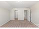 Cozy carpeted bedroom featuring a closet and an open doorway, ideal for a comfortable living space at 4679 Hopsack Dr # Cal0108, Indian Trail, NC 28079