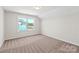 Bright bedroom featuring neutral carpet, a window and natural light at 4679 Hopsack Dr # Cal0108, Indian Trail, NC 28079