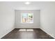 Neutral bedroom with hardwood floors and a window at 4679 Hopsack Dr # Cal0108, Indian Trail, NC 28079
