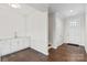 Entryway with a wet bar with white cabinets and hardwood floors at 4679 Hopsack Dr # Cal0108, Indian Trail, NC 28079
