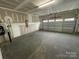 Unfinished two car garage with painted drywall and sealed concrete floors at 4679 Hopsack Dr # Cal0108, Indian Trail, NC 28079