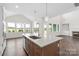 Gourmet kitchen with island and views to breakfast nook featuring hardwood floors and modern amenities at 4679 Hopsack Dr # Cal0108, Indian Trail, NC 28079