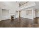Open living room featuring a fireplace, built-in shelves, and a wet bar at 4679 Hopsack Dr # Cal0108, Indian Trail, NC 28079