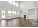 Bright living room with a fireplace, built-ins, and tall windows overlooking the backyard at 4679 Hopsack Dr # Cal0108, Indian Trail, NC 28079