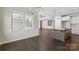 Open-concept living space flowing into the kitchen with hardwood floors and plenty of natural light at 4679 Hopsack Dr # Cal0108, Indian Trail, NC 28079