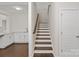 Staircase with hardwood treads and white risers adjacent to the kitchen at 4679 Hopsack Dr # Cal0108, Indian Trail, NC 28079