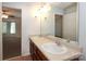 This bathroom includes double sinks, a large mirror, a vanity, and tile flooring at 1125 Kurt Ct, Charlotte, NC 28209