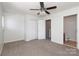 This bedroom features a ceiling fan, double closets, and an attached bathroom at 1125 Kurt Ct, Charlotte, NC 28209