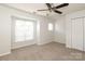 This bedroom features a ceiling fan, a closet, and a large window at 1125 Kurt Ct, Charlotte, NC 28209