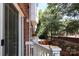 An exterior shot of the home featuring brick accents, a white porch and railing, and a view of the surrounding community at 1125 Kurt Ct, Charlotte, NC 28209
