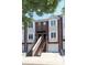 Brick townhome with white trim, attached garages, and shared staircase leading to front doors at 1125 Kurt Ct, Charlotte, NC 28209