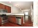 Kitchen featuring stainless steel appliances, granite countertops, wooden cabinetry, and an open floor plan at 1125 Kurt Ct, Charlotte, NC 28209