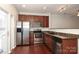 Kitchen features stainless steel appliances, wooden cabinets, granite countertops, and a stainless steel sink at 1125 Kurt Ct, Charlotte, NC 28209