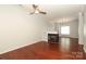 Cozy living room featuring hardwood floors, a fireplace, and a ceiling fan at 1125 Kurt Ct, Charlotte, NC 28209