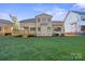 Back of home featuring a large grassy yard, deck, and stucco exterior at 4023 Randolph Rd, Charlotte, NC 28211