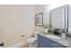 Powder room with gray cabinets, granite counters and black faucet at 4023 Randolph Rd, Charlotte, NC 28211