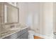 Bathroom with granite counters, modern mirror, and gray cabinets with hardware at 4023 Randolph Rd, Charlotte, NC 28211