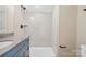 Bathroom features modern shower, gray counters and blue cabinets at 4023 Randolph Rd, Charlotte, NC 28211