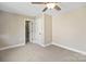 Neutral bedroom featuring a ceiling fan and a double door closet at 4023 Randolph Rd, Charlotte, NC 28211