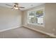 Neutral bedroom featuring a ceiling fan and a window allowing natural light at 4023 Randolph Rd, Charlotte, NC 28211