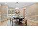 Elegant dining area featuring a modern light fixture and cozy seating, perfect for entertaining guests at 4023 Randolph Rd, Charlotte, NC 28211