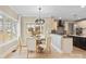 Modern dining area adjacent to kitchen with a contemporary light fixture and neutral color palette at 4023 Randolph Rd, Charlotte, NC 28211