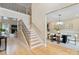 Spacious foyer with staircase and hardwood floors, leading to a dining area and other living spaces at 4023 Randolph Rd, Charlotte, NC 28211