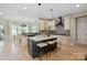 Stylish kitchen featuring a center island with bar seating, modern lighting, and adjacent dining area at 4023 Randolph Rd, Charlotte, NC 28211