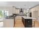 Bright kitchen featuring stainless steel appliances, an island with seating, and ample counter space at 4023 Randolph Rd, Charlotte, NC 28211