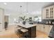 Bright, open kitchen featuring a central island, modern appliances and hardwood floors at 4023 Randolph Rd, Charlotte, NC 28211