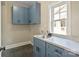 Light and bright laundry room with blue cabinets, gray floors and countertops, and a stainless steel sink at 4023 Randolph Rd, Charlotte, NC 28211