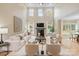 Bright living room features a fireplace, tall windows, and neutral furniture at 4023 Randolph Rd, Charlotte, NC 28211