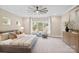 Spacious bedroom with a large window, ceiling fan, and comfortable seating area at 4023 Randolph Rd, Charlotte, NC 28211