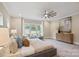 Bright bedroom features a ceiling fan, large window, and elegant furnishings at 4023 Randolph Rd, Charlotte, NC 28211