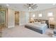 Spacious bedroom with neutral colors, featuring a ceiling fan and ample natural light at 4023 Randolph Rd, Charlotte, NC 28211
