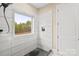 Modern walk-in shower features sleek tile work, window, and built-in shelving at 4023 Randolph Rd, Charlotte, NC 28211