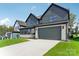 Two-story home with gray siding, white accents, and a two-car garage at 166 Windy Dell Dr, Tega Cay, SC 29708