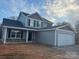 Charming two-story home with gray siding, stone accents, and a two-car garage at 805 W Main St, Marshville, NC 28103