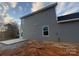 Newly constructed home with gray siding and concrete back patio ready for landscaping at 805 W Main St, Marshville, NC 28103