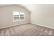 Cozy bedroom with vaulted ceiling, large window and neutral carpet at 126 Brixham Loop, Troutman, NC 28166